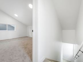 Edmonton apartment for rent - A room with a carpeted floor and a staircase.