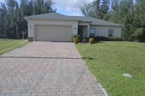 Cape Coral house for rent - A house with a driveway in front of it.