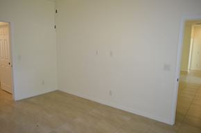 Cape Coral house for rent - A room with white walls and wooden flooring.