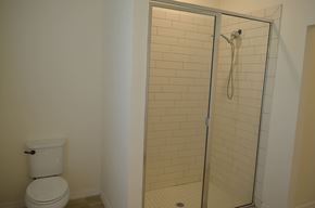 Cape Coral house for rent - A white toilet next to a glass shower door.