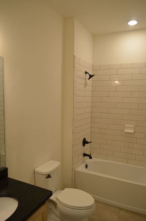 Cape Coral house for rent - A white toilet sits next to a sink in a bathroom.