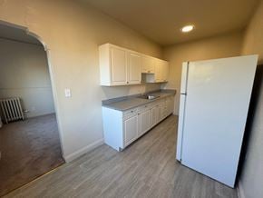 Alameda apartment for rent - A kitchen with white cabinets and a white refrigerator.
