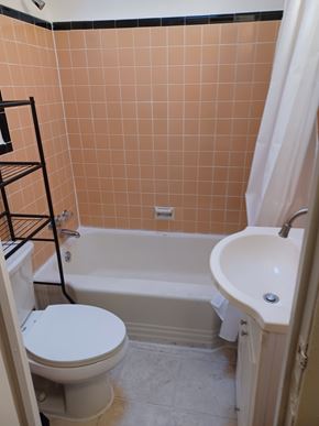 Philadelphia house for rent - A bathroom with a toilet, sink, and bathtub.