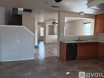 San Antonio house for rent - A kitchen with a black dishwasher and brown cabinets.