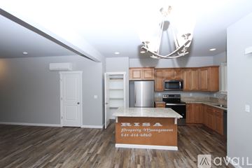 Salem house for rent - A kitchen with a counter that says "PRISA Property Management" on it.