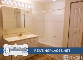 Augusta house for rent - A room with wooden floors and a chandelier.