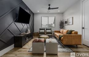 Hurricane house for rent - A modern living room with a dark grey accent wall and a large flat screen TV mounted on it.
