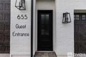 Hurricane house for rent - A black door with a glass window and a sign that says Guest Entrance.