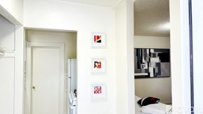 South Salt Lake apartment for rent - A white door is open to a hallway with pictures on the wall.