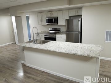 Aliquippa apartment for rent - A kitchen with a granite countertop and stainless steel appliances.