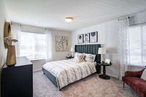 Bear townhouse for rent - a bedroom with a bed and two windows