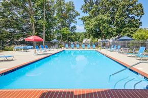 Bear townhouse for rent - a swimming pool with chairs and tables around it