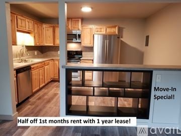 Pueblo apartment for rent - A kitchen with wooden cabinets and a refrigerator is on offer for rent.