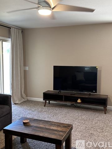 San Tan Valley house for rent - A living room with a television and a coffee table.