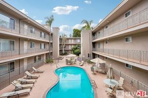 Santa Monica condo for rent - A kitchen with wooden cabinets and granite countertops.