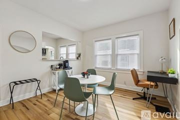 Indianapolis house for rent - A living room with a dining table and chairs.