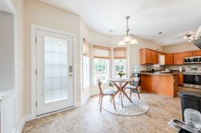 Jacksonville house for rent - A kitchen with a dining table and chairs in the middle of the room.