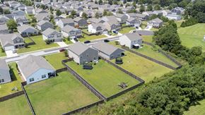 New Bern house for rent - A large grassy area with a fence and a house in the middle.