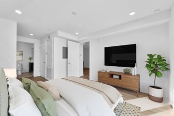 Los Angeles apartment for rent - A modern living room with a white sofa and a wooden entertainment center.