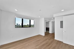 Los Angeles apartment for rent - A spacious room with wooden floors and a large window.