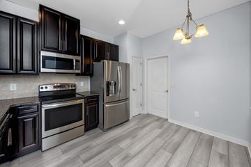 Clearwater house for rent - A kitchen with dark brown cabinets and stainless steel appliances.