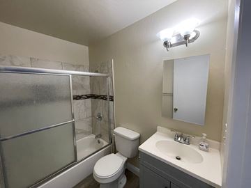 Antioch apartment for rent - A bathroom with a toilet, sink, and shower.