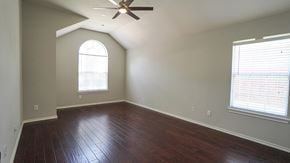 Rockwall house for rent - A room with a ceiling fan and a window with blinds.
