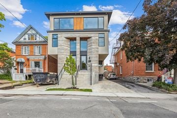 Ottawa apartment for rent - A modern two-story house with a large front yard.