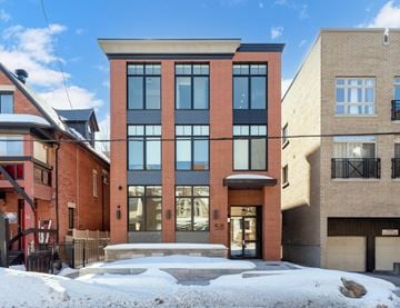 Ottawa apartment for rent - A red brick building with a black railing in front.