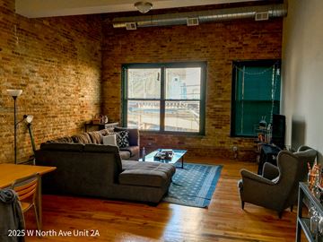 Chicago apartment for rent - a living room with a couch and a chair and a window