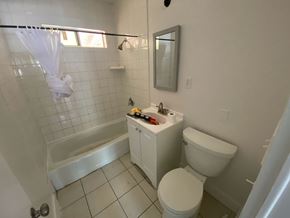 Escondido apartment for rent - A white bathroom with a toilet, sink, and tub.