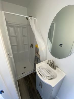 Escondido apartment for rent - A white bathroom with a sink, mirror and shower.