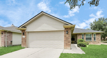 Katy house for rent - A house with a garage door and a driveway.