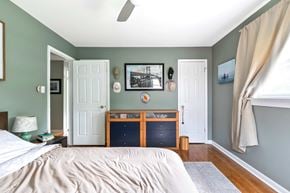 Richmond house for rent - A bedroom with a bed, nightstand, and a picture on the wall.