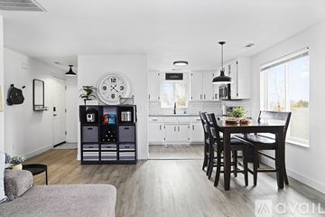 Grants Pass house for rent - A modern kitchen with a dining table and chairs.