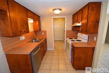 Ingleside apartment for rent - A kitchen with wooden cabinets and a stainless steel dishwasher.
