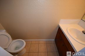 Ingleside apartment for rent - A bathroom with a toilet, sink, and tiled floor.
