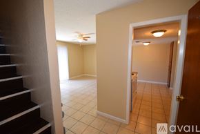 Ingleside apartment for rent - A hallway with a staircase on the left and a door on the right.