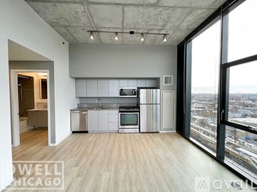 Chicago apartment for rent - A modern kitchen with stainless steel appliances and a view of the city.