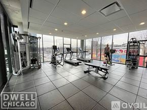 Chicago apartment for rent - A gym with a variety of equipment including treadmills, weights, and a bench.