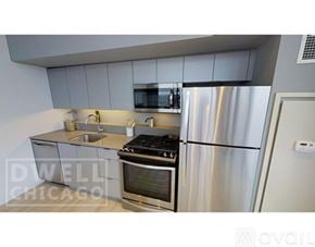 Chicago apartment for rent - A kitchen with a stove, refrigerator, and microwave.