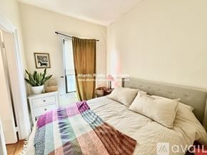 Boston apartment for rent - A large red brick building with a black car parked in front.