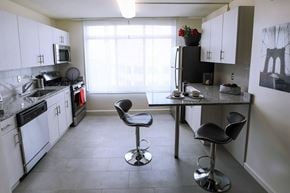 Bethesda apartment for rent - a kitchen with white cabinets and a table with chairs
