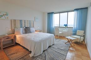 Bethesda apartment for rent - a bedroom with a bed and a desk and a window
