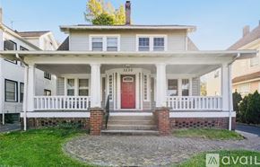 Cleveland Heights house for rent - A white house with a porch and a chimney.