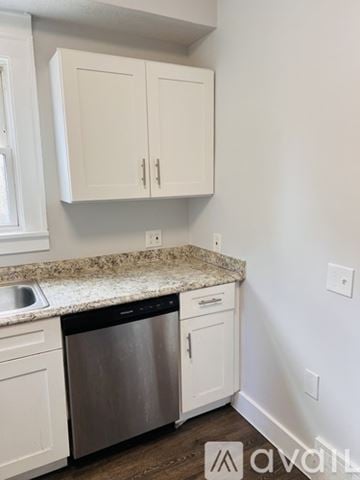 Cleveland Heights house for rent - A kitchen with white cabinets and a granite countertop.