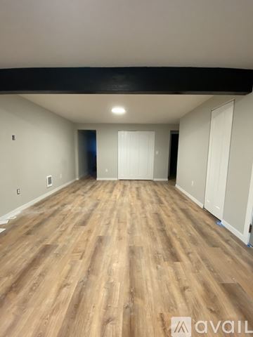 Cheney apartment for rent - A kitchen with white cabinets and a black countertop.