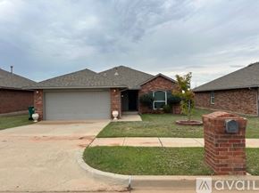 Oklahoma City house for rent - A house with a brick chimney and a garage door.