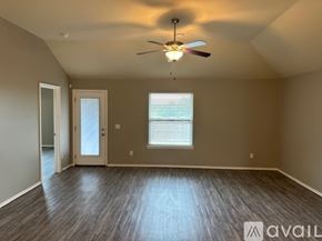Oklahoma City house for rent - A spacious room with a ceiling fan and two windows.