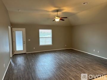 Oklahoma City house for rent - A kitchen with dark brown cabinets and a black refrigerator.